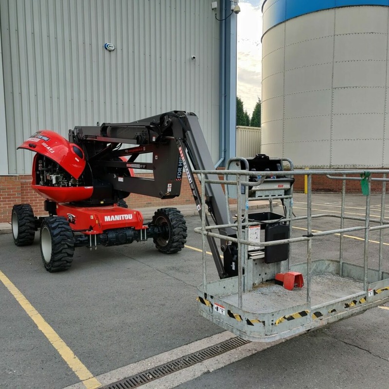 A red cherry picker outside an industrial unit in Cheshire