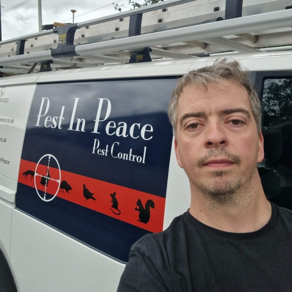 Jake in front of the Pest In Peace branded van 